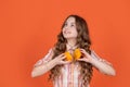 teen girl smile hold citric fruit on orange background