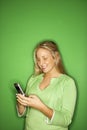 Teen girl smiling at cellphone Royalty Free Stock Photo