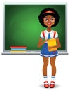 Teen girl standing in front of green school board with books Royalty Free Stock Photo