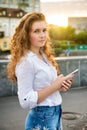 Teen girl standing with mobile phone outdoors Royalty Free Stock Photo
