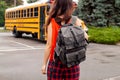 Teen Girl Standing Near Yellow School Bus Parked On The Street Royalty Free Stock Photo