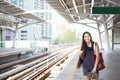 Teen girl standing on train platform station Royalty Free Stock Photo