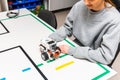 Teen girl student with diy robot on stem education class.Teen scientist working on new project.Stem education Learning To Program