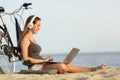Teen girl studying with a laptop on the beach Royalty Free Stock Photo