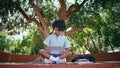 Teen girl studying laptop sitting sunny park. Relaxed african teenager learning. Royalty Free Stock Photo