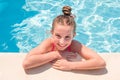 Teen girl in swimming pool squinting her eyes