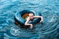 Teen girl swimming using a swim tube Royalty Free Stock Photo