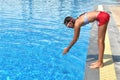 Child girl dives into the pool. Girl learning to swim autdoor. Swimming pool in the hotel. Children swim in the outdoor pool.