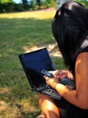 Teen girl text messaging while using laptop