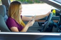 Teen girl texting and driving Royalty Free Stock Photo