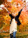 Teen girl throwing leaves in autumn Royalty Free Stock Photo