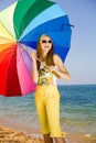 Teen girl with umbrella on seashore Royalty Free Stock Photo