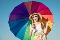 Teen girl with umbrella standing on the beach at the day time. Royalty Free Stock Photo