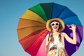 Teen girl with umbrella standing on the beach at the day time. Royalty Free Stock Photo