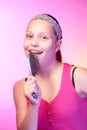 Teen girl uses hairbrush like a microphon