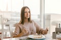 Teen girl using smart phone in cafe Royalty Free Stock Photo