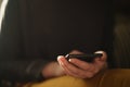 Teen girl using smartphone backlit by window light