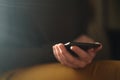 Teen girl using smartphone backlit by window light