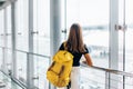 Teen girl waiting for international flight in airport departure terminal Royalty Free Stock Photo