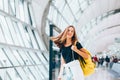 Teen girl waiting for international flight in airport departure terminal Royalty Free Stock Photo