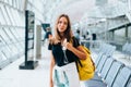 Teen girl waiting for international flight in airport departure terminal