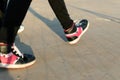 Teen girl walking with pink sneakers