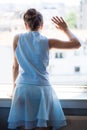 Teen girl wave with hand on window