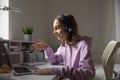 Teen girl wears headphones conference calling studying with online tutor Royalty Free Stock Photo