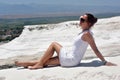 Teen girl in white on a background of calcium travertine