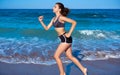 Teen girl workout running in beach shore