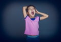 Teen girl yawns wants to sleep on a gray Royalty Free Stock Photo