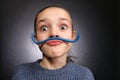 Teen girl 9-12 years old, looks into the frame, emotional studio portrait on a gray background Royalty Free Stock Photo