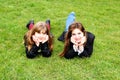 Teen girls laying on the green grass Royalty Free Stock Photo