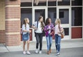 Teen girls leaving school talking and walking together