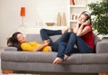 Teen girls listening to music on couch