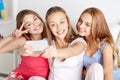 Teen girls with smartphone taking selfie at home Royalty Free Stock Photo