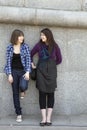 Teen girls talking at stone wall