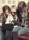 Teen girls using laptop on the bench Royalty Free Stock Photo