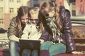 Teen girls using laptop on the bench Royalty Free Stock Photo