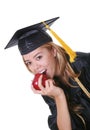 Teen graduate eating apple Royalty Free Stock Photo