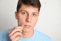 Teen guy applying acne healing patch on background Royalty Free Stock Photo