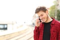 Teen guy calling on the mobile phone waiting a train Royalty Free Stock Photo