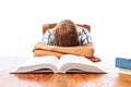 Teen guy fell asleep sitting with books, student sleeping at Desk in Studio on white background Royalty Free Stock Photo