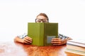 Teen guy fell asleep sitting with books, student sleeping at Desk in Studio on white background Royalty Free Stock Photo