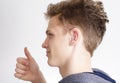 Teen with hearing aid showing thumb up Royalty Free Stock Photo