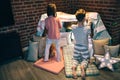 Teen helping little sister prepare a makeshift tent