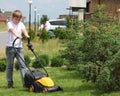 Teen helps mow the lawn Royalty Free Stock Photo