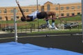 Teen participating in the high jump at a track and field event