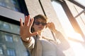 Teen girl wear stylish glasses stand on city street looking at camera.