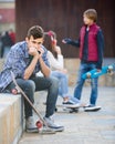 teen and his friends after conflict outdoors Royalty Free Stock Photo